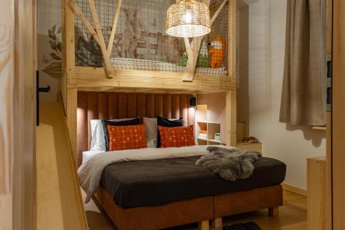 a bedroom with a bed with a wooden headboard at Panocek i Babka in Białka Tatrzanska