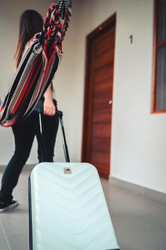 a woman is pulling a suitcase in a room at Taki Tambo Lodge in Tarapoto