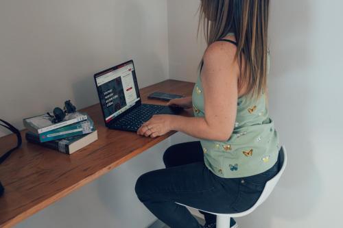 a young girl sitting at a desk with a laptop computer at Taki Tambo Lodge in Tarapoto