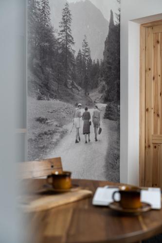 a black and white photo of three people walking down a road at Panocek i Babka in Białka Tatrzanska