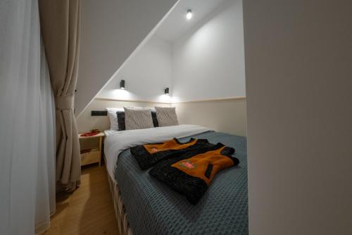 a bedroom with a bed with two robes on it at Panocek i Babka in Białka Tatrzanska