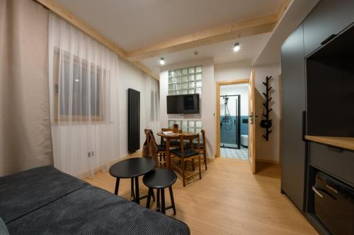 a bedroom with a bed and a table with chairs at Panocek i Babka in Białka Tatrzanska