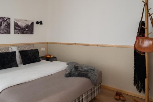 a bedroom with a bed with a blanket on it at Panocek i Babka in Białka Tatrzanska