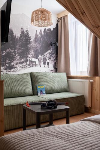 a living room with a couch and a table at Panocek i Babka in Białka Tatrzanska