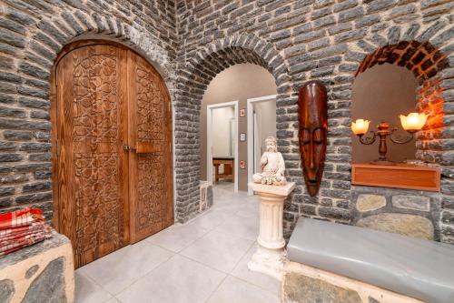 a stone hallway with a door and a statue at Club Aquarium Hotel & Spa in Guvercinlik