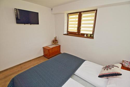 Ένα ή περισσότερα κρεβάτια σε δωμάτιο στο Apartamenty w Długoszówce