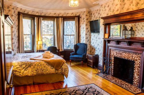 a bedroom with a bed and a fireplace at Beacon Inn 1087 in Brookline