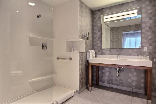 a bathroom with a sink and a shower at Courtyard by Marriott Quebec City in Quebec City