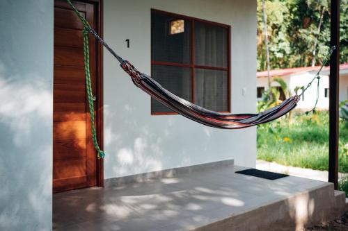 a hammock hanging off the side of a house at Taki Tambo Lodge in Tarapoto