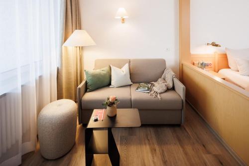 a living room with a couch and a table at Boutiquehotel Ochsen in Lenzkirch