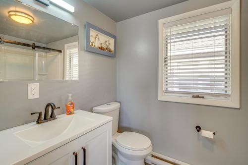 a bathroom with a sink and a toilet and a mirror at Renovated Ocean City Retreat - Walk to Beach! in Ocean City