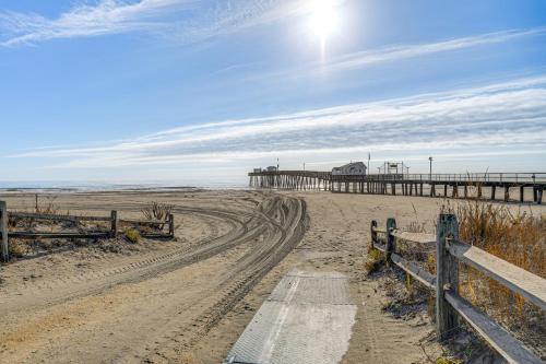 a beach with a pier and a dirt road at Renovated Ocean City Retreat - Walk to Beach! in Ocean City
