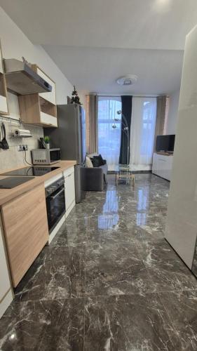 a kitchen with a large marble floor in a room at Studio u Arka in Kłodzko