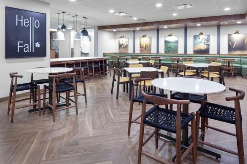 a restaurant with tables and chairs and a bar at Fairfield Inn & Suites by Marriott Fort Morgan in Fort Morgan