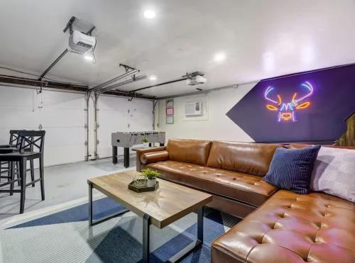a living room with a leather couch and a table at Pikes Divine - Prime Spot BBQ Fire Pit Alfresco in Colorado Springs