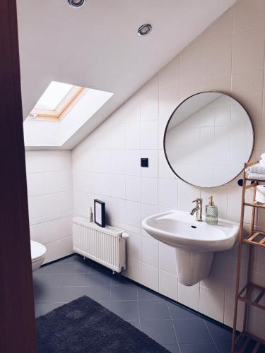 a bathroom with a sink and a mirror at GóralSki in Wisła