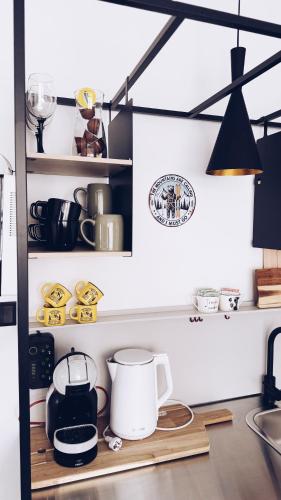 a kitchen with a shelf with pots and pans at GóralSki in Wisła