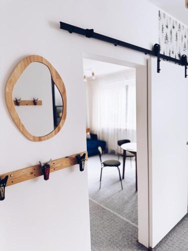 a mirror on a wall next to a living room at GóralSki in Wisła