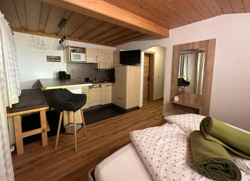 a living room with a couch and a kitchen at Gästehaus Emberger in Wagrain