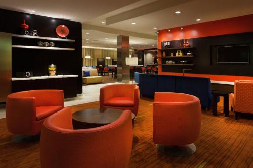 a lobby with orange chairs and a pool table at Courtyard by Marriott San Angelo in San Angelo