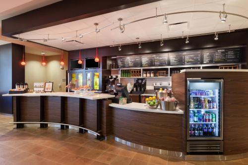 a bar in a restaurant with a refrigerator at Courtyard by Marriott San Angelo in San Angelo