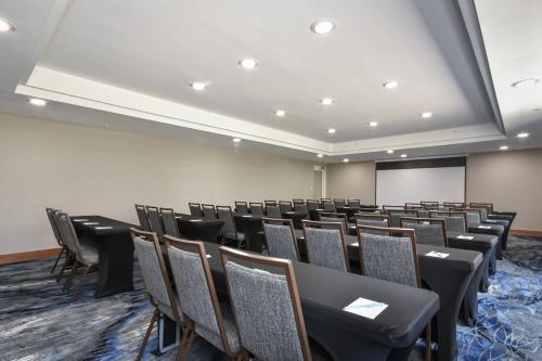 a conference room with chairs and a projection screen at Fairfield by Marriott Inn & Suites Columbia Harbison in Columbia