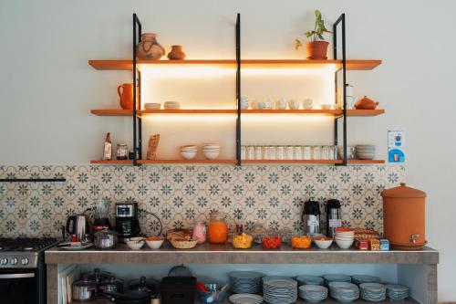 a kitchen with a counter with plates and bowls at Taki Tambo Lodge in Tarapoto