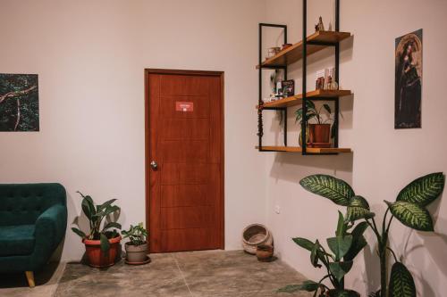 a living room with a door and some plants at Taki Tambo Lodge in Tarapoto