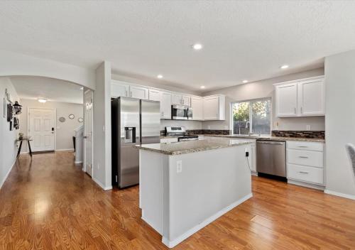 a kitchen with white cabinets and stainless steel appliances at Urban Escape Steps to Downtown in Boise