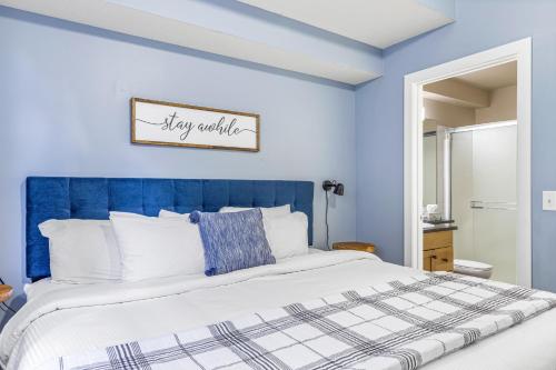 a blue bedroom with a large bed with a blue headboard at Mystic Chalet managed by Little Sister Getaways in Canmore