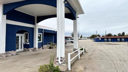 a blue and white building with a white pole at Apollo Lodge and RV Park in Fairfield