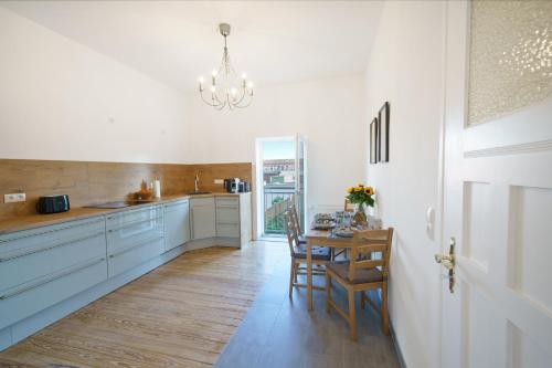 a kitchen with a table and chairs and a chandelier at charming living - Parking - MA - PFALZ - A61 in Ludwigshafen am Rhein