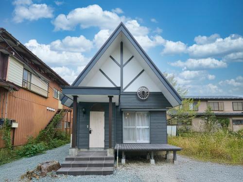 a small house with a bench in front of it at Suite Viila Sankakurojji Yamanakako in Yamanakako