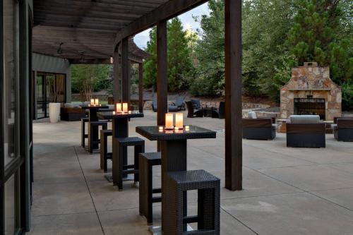 a group of tables and chairs with candles on them at Courtyard by Marriott Raleigh North/Triangle Town Center in Raleigh