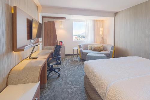 a hotel room with two beds and a desk at Courtyard by Marriott Saltillo in Saltillo