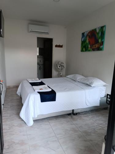 a bedroom with a large white bed in a room at HOTEL POSADA CAMPESTRE SAN JUAN in Monterrey
