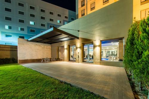 a building with a patio in a city at night at Courtyard by Marriott San Luis Potosi in San Luis Potosí