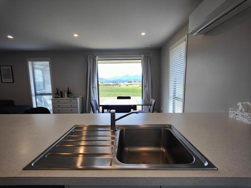 a kitchen with a sink and a counter top at Mountain View Getaway in Te Anau