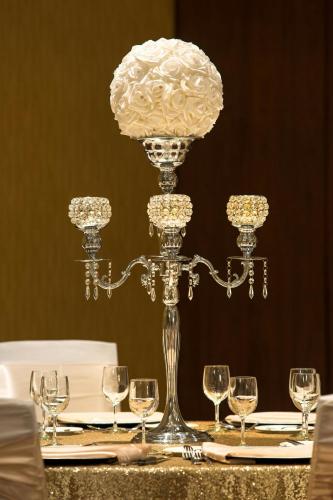 a table with a fancy centerpiece on a table with wine glasses at Courtyard by Marriott Calgary Airport in Calgary