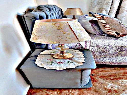 a table with a lamp on it next to a bed at Luxury 3-bedroom apartments 5-min to the Airport in Fès
