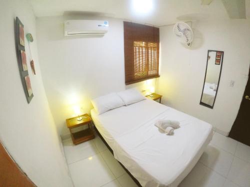 a small bedroom with a bed with a stuffed animal on it at Cristal Tayrona in Los Naranjos