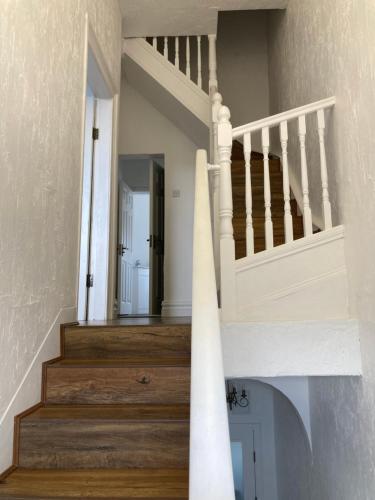 a staircase in a house with wooden floors at Blueberry Inn in Dundalk