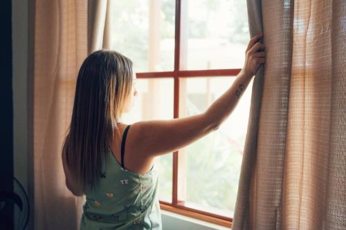 a woman is looking out of a window at Taki Tambo Lodge in Tarapoto