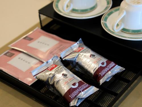 a shelf with bags of chocolate and plates on a table at Villa The Club 御殿場ウエスト in Gotemba