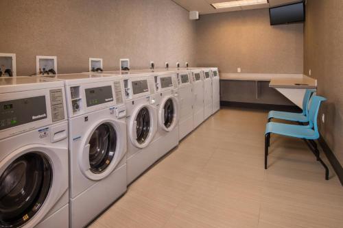 a laundry room with a row of washing machines at Fairfield Inn & Suites by Marriott Altoona in Altoona