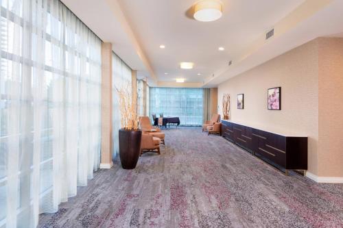 a lobby with a waiting room with chairs and a desk at Courtyard by Marriott Santa Ana Orange County in Santa Ana