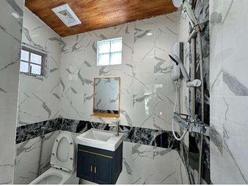 a bathroom with a toilet and a sink and a mirror at 3BR Villa near Boat Avenue Laguna beach in Bang Tao Beach