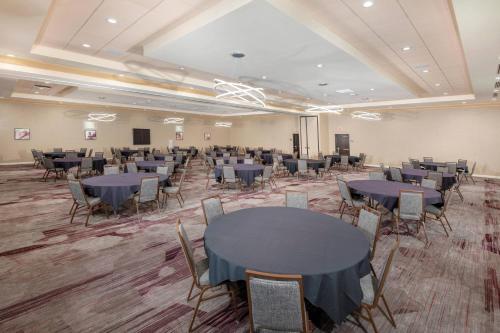 a banquet hall with tables and chairs in a room at Courtyard by Marriott Santa Ana Orange County in Santa Ana
