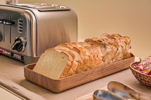 a loaf of bread in a basket next to a toaster at In Stay Guesthouse in Seogwipo