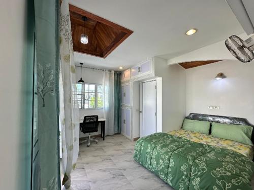 a bedroom with a green bed and a desk at 3BR Villa near Boat Avenue Laguna beach in Bang Tao Beach